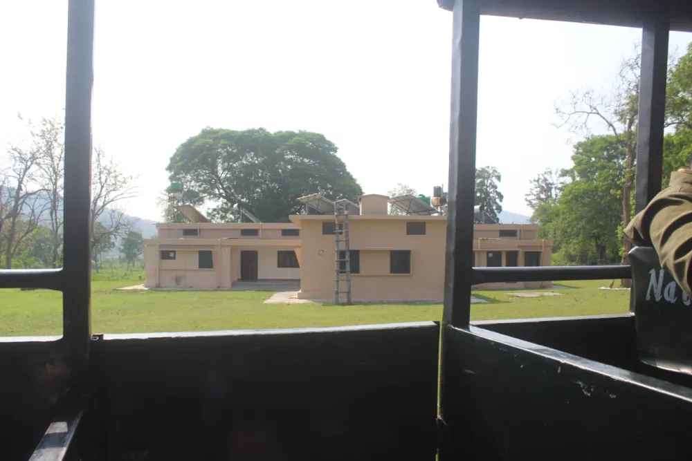 Dhikala forest rest house buildings viewed from a safari canter