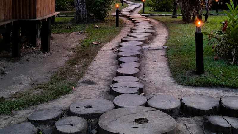 Lit stone pathway through resort grounds at dusk